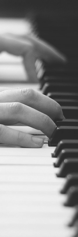 Hands playing on a traditional piano